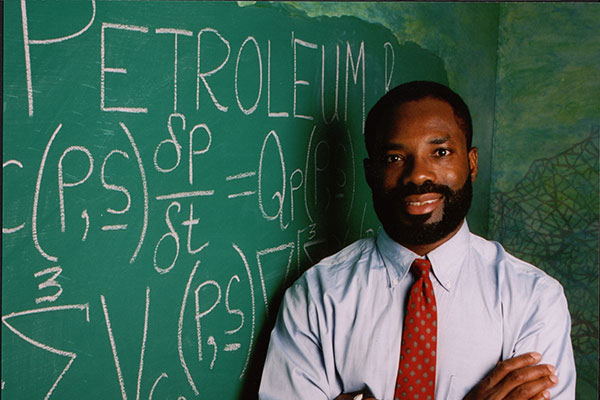 Philip_Emeagwali_with_scribbled_Exxon-Mobil_equation1s